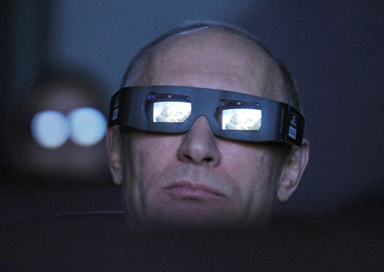 Russia's Prime Minister and President-elect Vladimir Putin, wearing a pair of glasses, watches the main program of the Planetarium on the Day of Aviation and Cosmonautics and the 51st anniversary of Yuri Gagarin's historic first space flight in Moscow on April 12.
