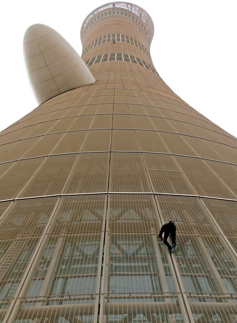 Alain Robert climbs up The Torch hotel in Doha, Qatar on April 12.