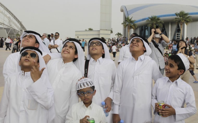 A crowd gathers to watch Alain Robert climb 985 feet up The Torch hotel in Doha, Qatar on April 12.