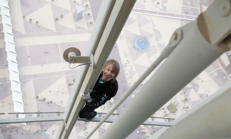 French climber Alain Robert scales The Torch hotel, the tallest tower in Doha, on April 12.