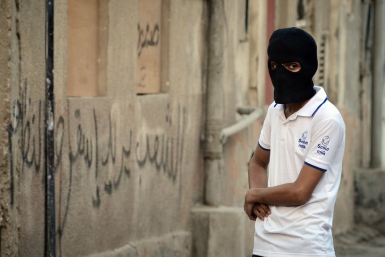 A masked Bahraini Shiite Muslim boy stands in the street during clashes with riot police following a demonstration in the village of Belad al-Qadeem, south of Manama, on April 12. Protesters are against the Formula One race taking place on April 22, and in solidarity with Abdul Hadi al-Khawaja, a prisoner who went on hunger strike 64 days ago.