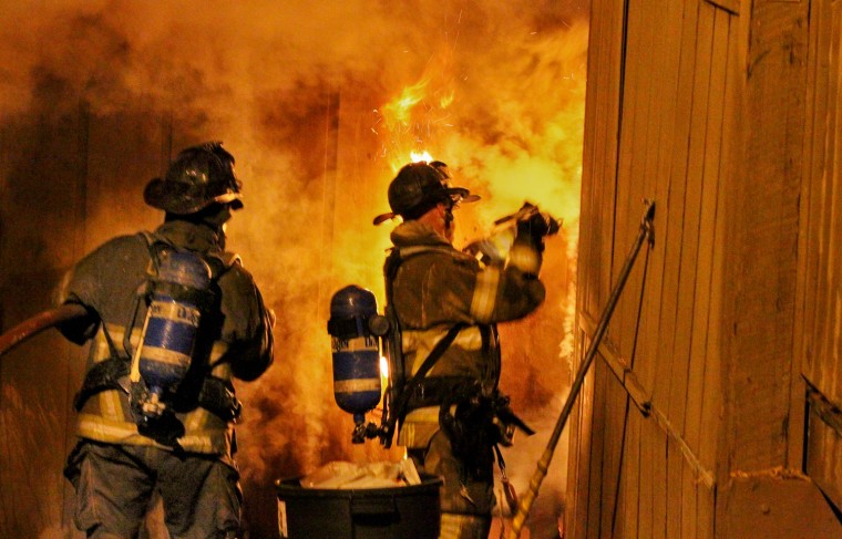 Firemen work at the scene of a condominium complex fire early on April 13, in south DeKalb County in Georgia.