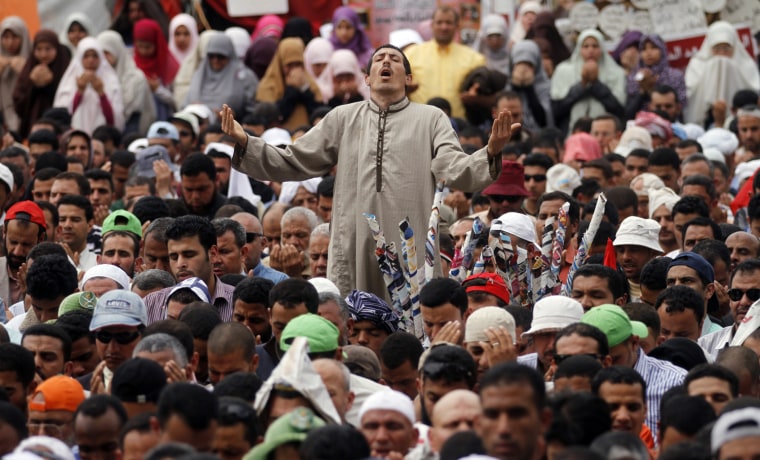 Thousands of Islamists attend Friday prayers before a rally in Tahrir Square to denounce the presidential candidacies of Hosni Mubarak-era officials, including that of his former spy chief in Cairo, Egypt, on April 13. Supporters of the country's most influential political group, the Muslim Brotherhood, along with ultraconservative Salafis and other Islamists packed the capital's Tahrir Square, which was the epicenter of the uprising that ousted Mubarak a year ago.