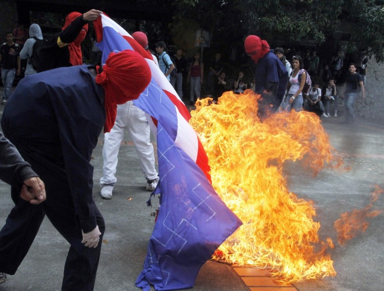 Activists burn the U.S. flag at Antioquia University in Medellin, on April 13 as they protest against the VI Summit of the Americas which will take place in Cartagena, Columbia April 13-15.