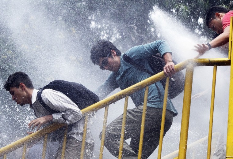 Police spray water cannons at activists during a protest April 13 at University of Antioquia in Medellin, Colombia. They were protesting against the VI Summit of the Americas taking place April 13-15 in Cartagena, Colombia.