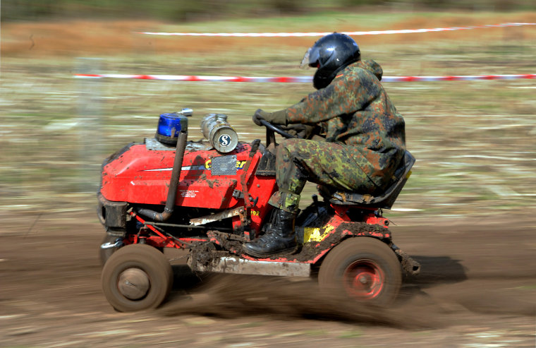 A man competes in a ride-on mower race in Aukrug-Homfeld, Germany, April 14. Around a dozen teams compete with their modified ride-on mowers with up to 120 horsepower and top speeds of more than 60 mph.