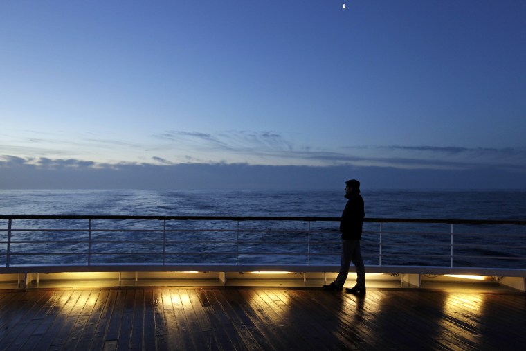 A passenger of the MS Balmoral Titanic memorial cruise ship gazes out to the Atlantic Ocean following a memorial service marking the 100-year anniversary of the Titanic disaster in the early hours of April 15. The Titanic passenger liner was built in Belfast, and sank in the North Atlantic Ocean on its maiden voyage from England to New York, in the early hours of April 15, 1912, after colliding with an iceberg. More than 1,500 people perished in the sinking.
