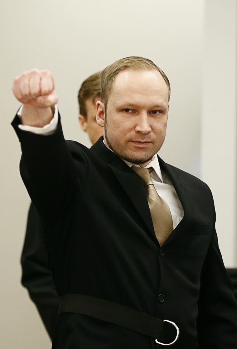 Anders Behring Breivik raises his fist as he arrives to courtroom for the first day of his trial in Oslo, Monday.
