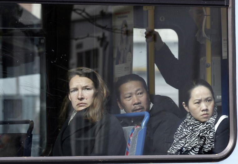 People look from inside a tram as they pass by the court in Oslo where the trial of Anders Behring Breivik is being held.