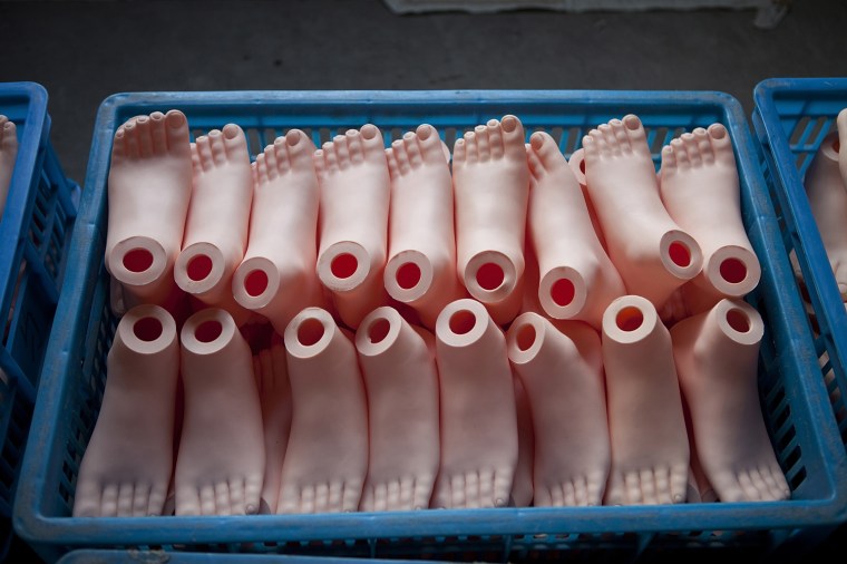 Plastic feet are stored before being attached to sex dolls at the Jiamei Plastic Toy Factory on February 18, 2012 in Ningbo, China. Pictures made available April 16.