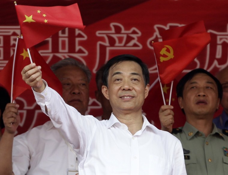 China's Chongqing Municipality Communist Party Secretary Bo Xilai waves a Chinese national flag during the opening ceremony of a revolutionary song singing concert at Chongqing Olympic Sports Centre in Chongqing municipality in this June 29, 2011 file photo.