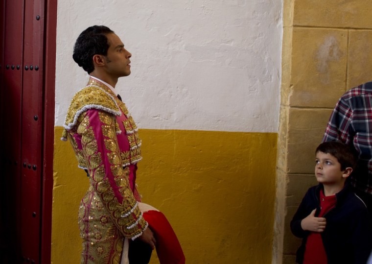 A young boy watches Colombian matador Luis Bolivar before the start of a bullfight in The Maestranza bullring in Seville, Spain on April 16.