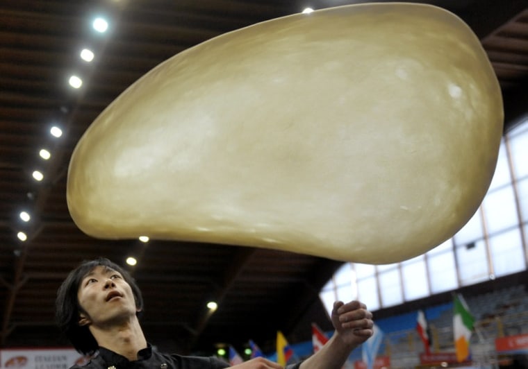 Tomofumi Takagi, of Japan, performs with his dough during the freestyle event, part of the Pizza World Championships, in Salsomaggiore Terme, northern Italy on April 18.