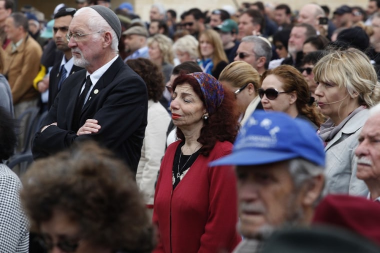 People observe two minutes of silence as sirens wail across Israel to mark Holocaust Remembrance Day on April 19, 2012 during the annual ceremony at the Yad Vashem memorial in Jerusalem. The state of Israel marks the annual Memorial Day commemorating the six million Jews murdered by the Nazis in the Holocaust during World War II. AFP PHOTO/POOL/GALI TIBBON (Photo credit should read GALI TIBBON/AFP/Getty Images)