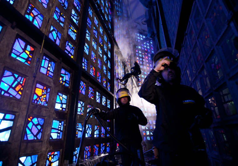 Industrial climbers clean window elements of the Kaiser Wilhelm Memorial Church on April 19, in Berlin.