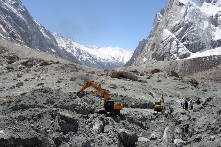 Pakistani military personnel use heavy machinery as they search for avalanche victims during an ongoing operation at Gayari camp near the Siachen glacier on April 18, 2012.
