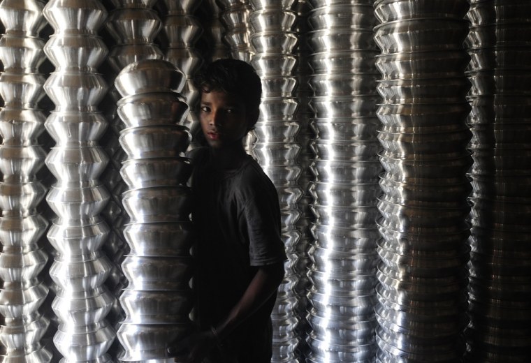 A young boy working at an aluminum pot making factory in Dhaka, Bangladesh on April 19.