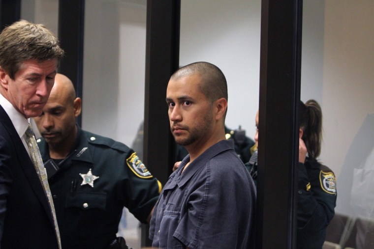 George Zimmerman, right, stands with his attorney Mark O'Mara as he makes his first appearance in front of a judge, via closed-circuit TV, at the Seminole County Correctional Facility in Sanford on April 12.