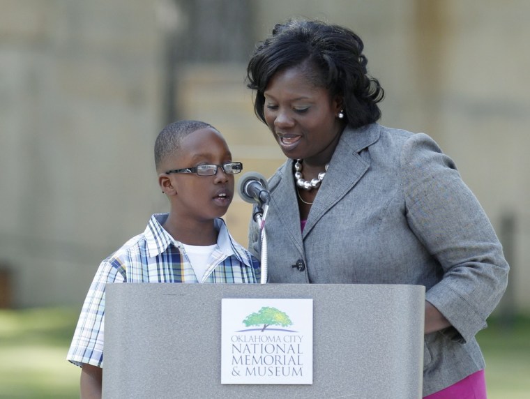 Carlos and Renee Moore, the brother and mother of Oklahoma City bombing victim Antonio Ansara Cooper Jr., read a portion of the list of 168 names of the victims during the 17th annual Remembrance Ceremony at the Oklahoma City National Memorial & Museum in Oklahoma City on April 19.