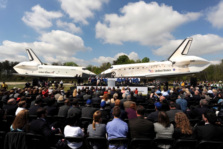 The Enterprise space shuttle, left, and Discovery space shuttle, right, face each other during the Discovery transfer ceremony at Smithsonian National Air and Space Museum's Steven F. Udvar-Hazy Center in Chantilly, Va. on April 19.