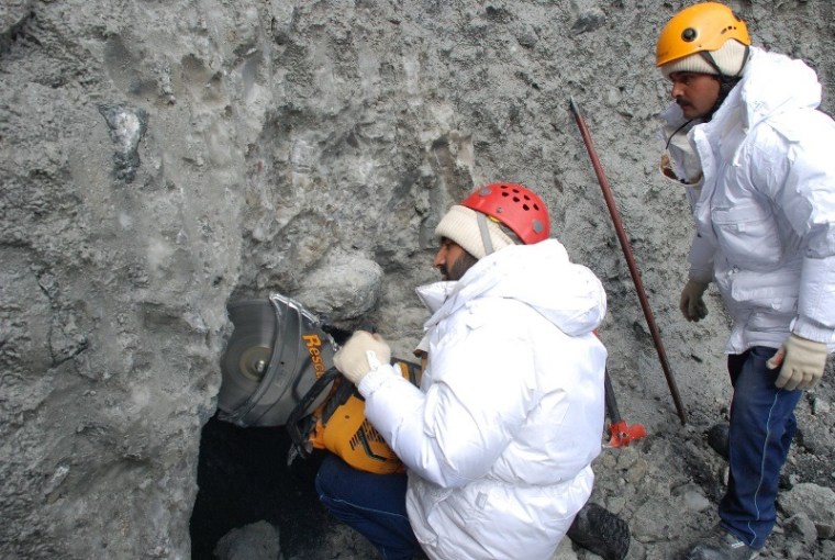 Rescue workers try to dig a tunnel at what was the Pakistan army's Gayari base in the Kashmir mountains to find bodies of the 139 people who were buried in an avalanche on April 7, 2012.