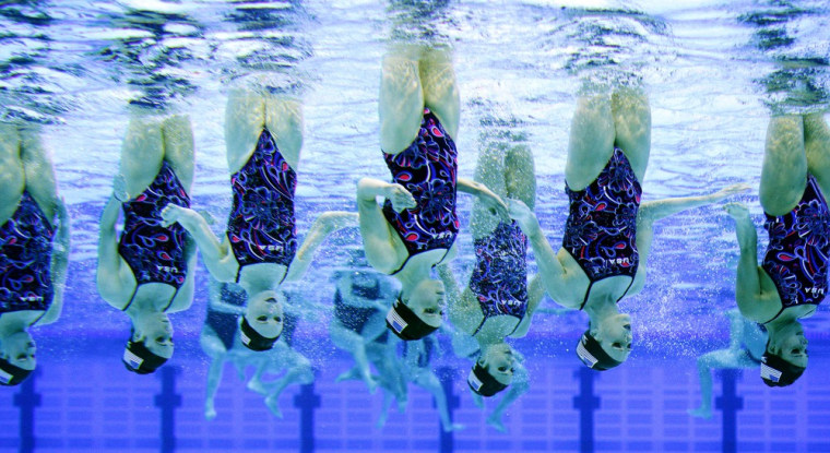 The Unites States team practice before the team technical routine at the FINA Olympic games synchronized swimming qualification competition at the London Aquatics Centre on April 19.