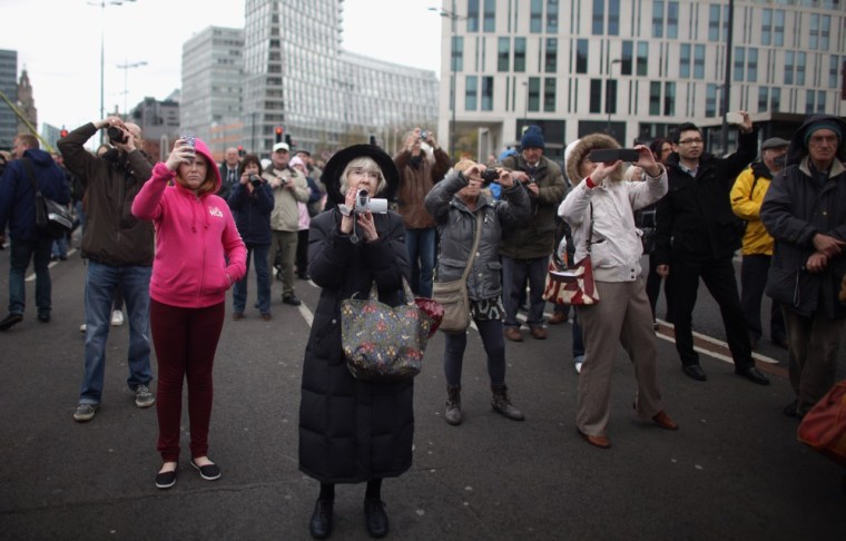 People photograph giant puppets on the streets of Liverpool, England on April 20. French street theatre company Royal De Luxe will be performing the Titanic Sea Odyssey over the next three days.