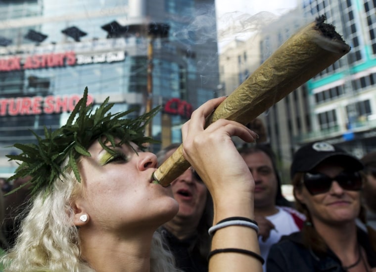 The Weed Fairy smokes a massive marijuana joint right at 4:20 p.m. as thousands take part in the annual marijuana 420 smoke off at Dundas Square in Toronto, Canada on April 20.
