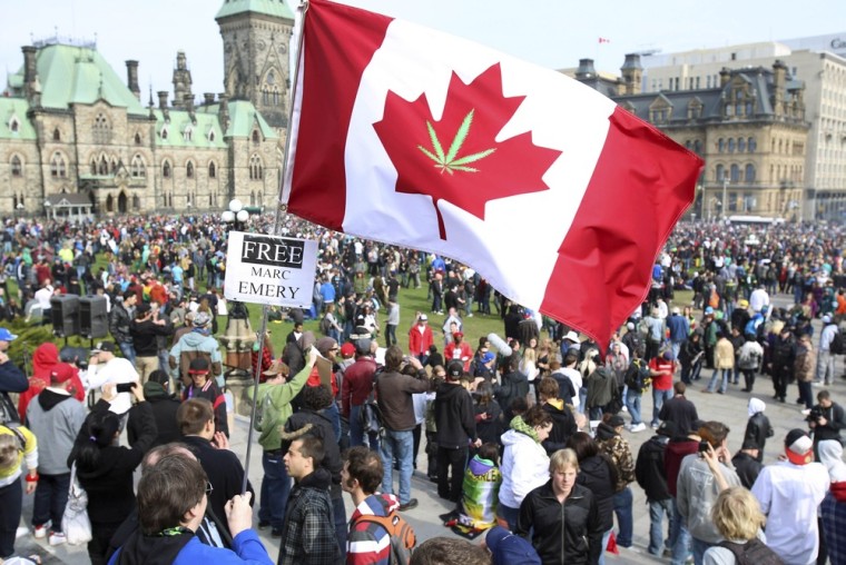 A Canadian flag with a marijuana leaf is flown during a 4/20 rally to demand the legalization of marijuana on Parliament Hill in Ottawa, Canada on April 20. Marijuana enthusiasts across Canada gather by the thousands every year on April 20 for an international celebration and protest for marijuana legalization.