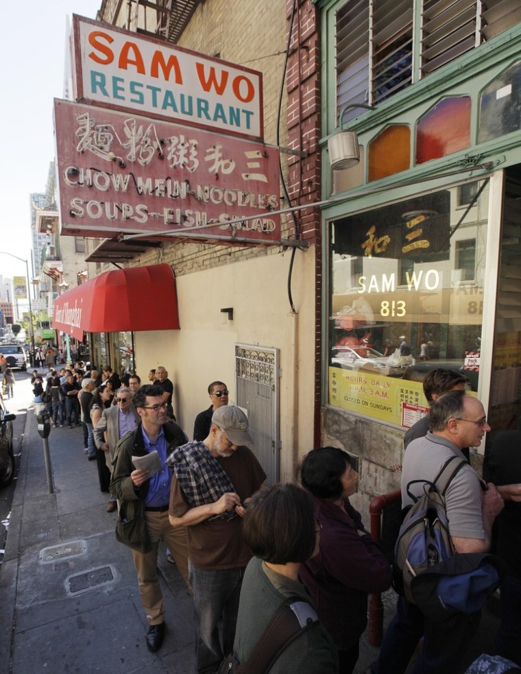 Customers line up for one final meal at the Sam Wo restaurant in Chinatown in San Francisco on Friday. The 100-year-old Chinese restaurant known for having