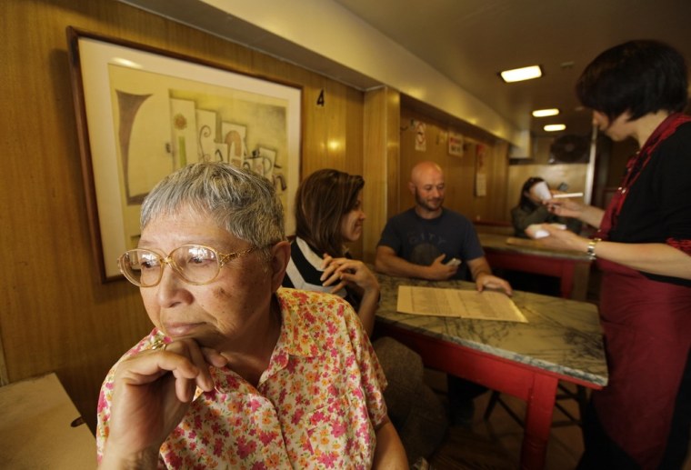 Darlene Lee, 71, looks out the window after ordering lunch one last time from waitress Fanny He, right, at the Sam Wo restaurant in San Francisco on Friday.