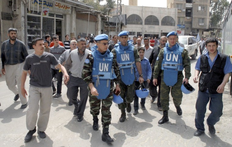 Moroccan Colonel Ahmet Himmiche, third from left, is leading the first U.N. monitoring team in Syria.