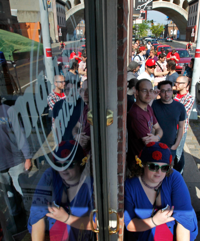Becky Blumenthal, from Philadelphia, right, waits to be one of the first people in the store on the fifth annual Record Store Day at Main Street Music, April 21, in Philadelphia.