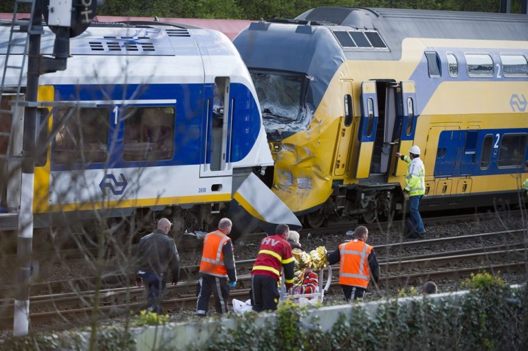Rescue workers evacuate injured passengers at the scene of a train collision near Amsterdam on Saturday.