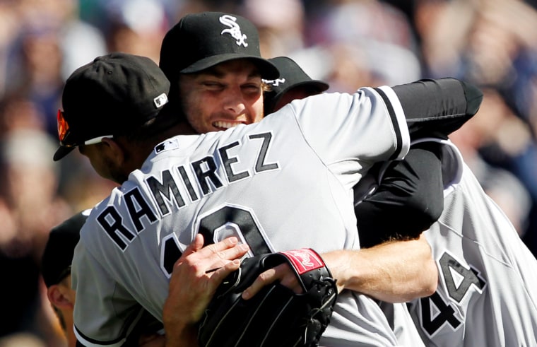 Chicago White Sox starting pitcher Philip Humber, center, is mobbed by teammates after pitching a perfect game against the Seattle Mariners, April 21, in Seattle. The White Sox won 4-0.