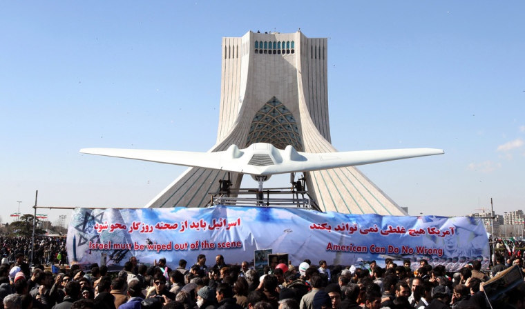Iranians gather around a replica of an American spy drone on display next to Azadi (Freedom) square during a ceremony marking the 33rd anniversary of the 1979 Islamic revolution in Tehran on Feb. 11.