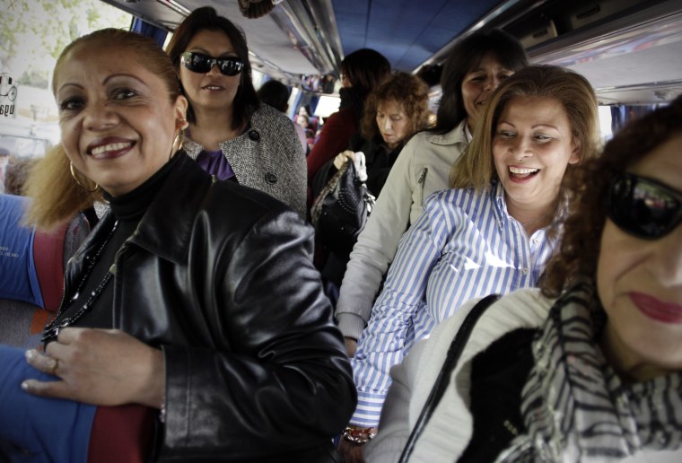 A group of women arrive in a bus before a meeting between men and women in Candeleda, Spain.