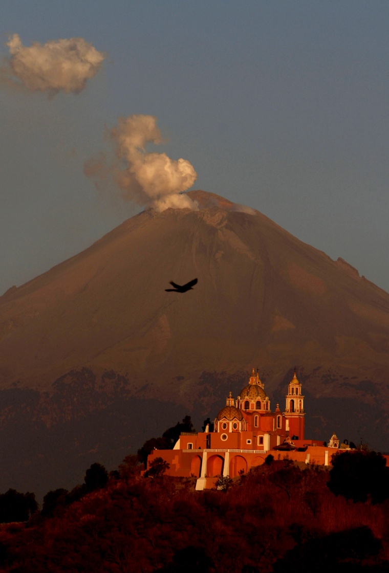 A plume of ash and steam rise from the Popocatepetl volcano overshadowing the Catholic church 'Nuestra Señora de los Remedios' or 'Our Lady of Remedies' in Cholula, Mexico, April 22.