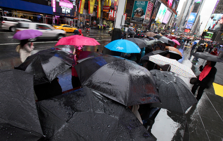 Umbrellas shelter people waiting to buy Broadway theater tickets in New York's Times Square, April 22.