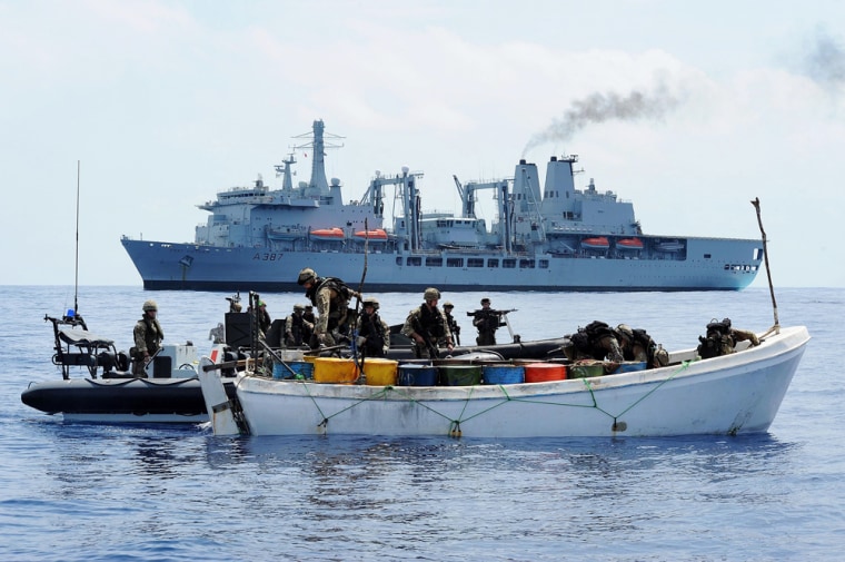 A suspected pirate vessel is searched by a boarding team from a U.K. naval vessel 350 nautical miles from the Somali coast in November.