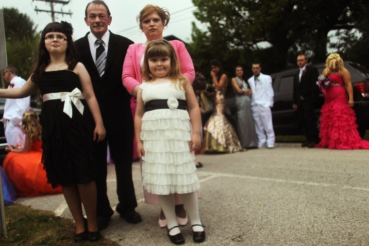 The Taylor family waits to attend the start of the Owsley County High School prom on on April 21 in Booneville, Ky.