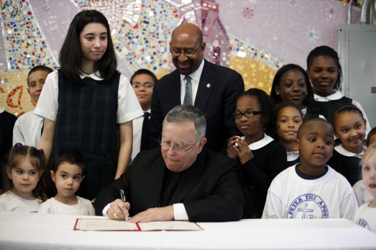Archbishop of Philadelphia, Charles Chaput, center, signs The Great Schools Compact as Philadelphia Mayor Michael Nutter and students watch during a news conference at St. Peter the Apostle Catholic Church on April 23 in Philadelphia. Chaput signed the compact, which has already received a planning grant and will compete for an implementation grant the Bill & Melinda Gates Foundation.