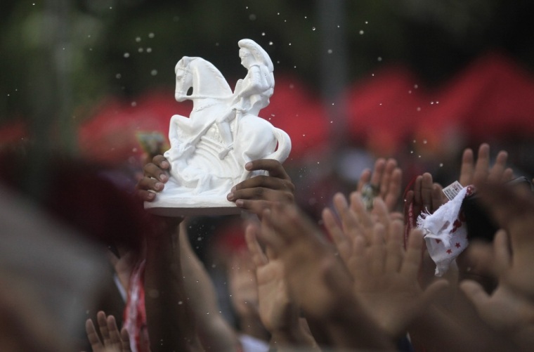 A member of the crowd holds up a figurine representing Saint George during the celebration of Sao Jorge's day in Rio de Janeiro, Brazil on April 23.