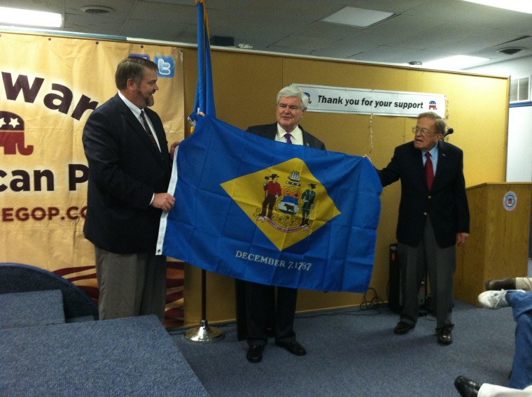 Newt Gingrich is presented with a Delaware flag following a speech at the state GOP headquarters in Wilmington, DE Monday night, April 23.