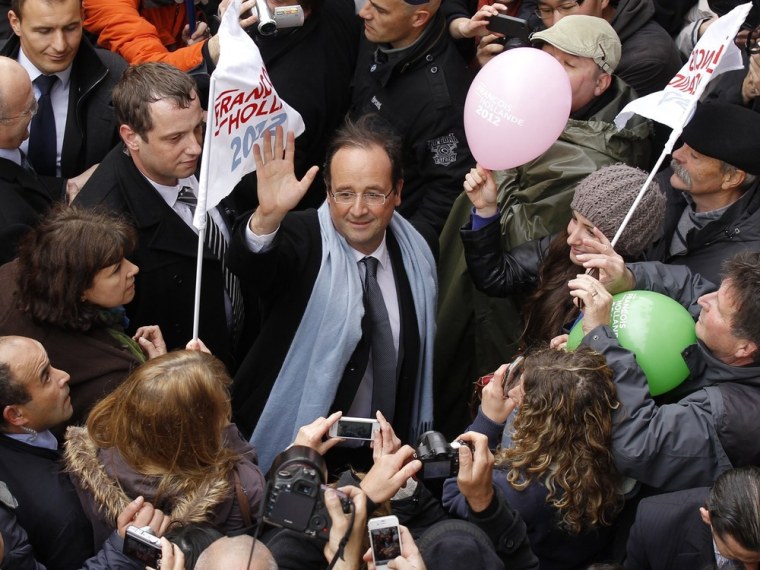 Francois Hollande, Socialist Party candidate for the 2012 French presidential election, waves to supporters as he walks in the street during a campaign visit in Quimper on Monday.