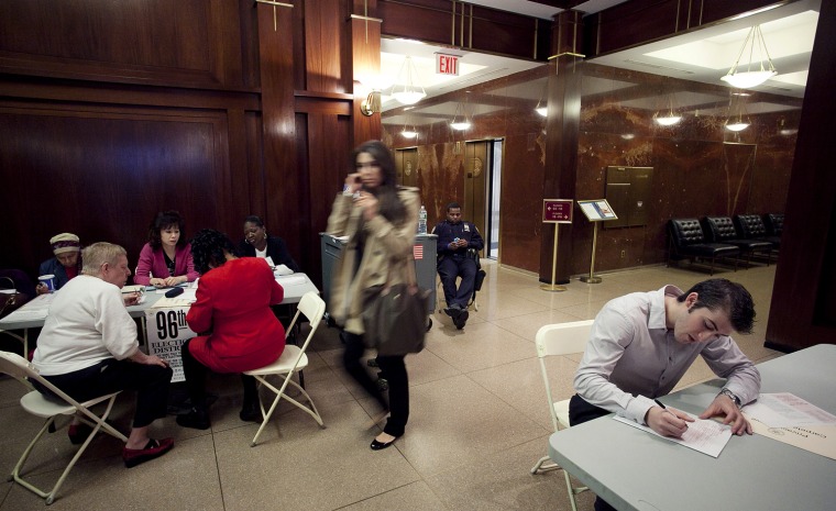 Brendan Reilly, right, completes an election affidavit prior to casting his ballot at a polling station in the lobby of his apartment building on Wall Street in New York, Tuesday, April 24. Voters in New York, Connecticut, Delaware, Rhode Island and Pennsylvania are voting in the presidential primaries Tuesday. Reilly, who voted for Ron Paul, is hoping for a brokered Republican convention to block Mitt Romney's nomination.