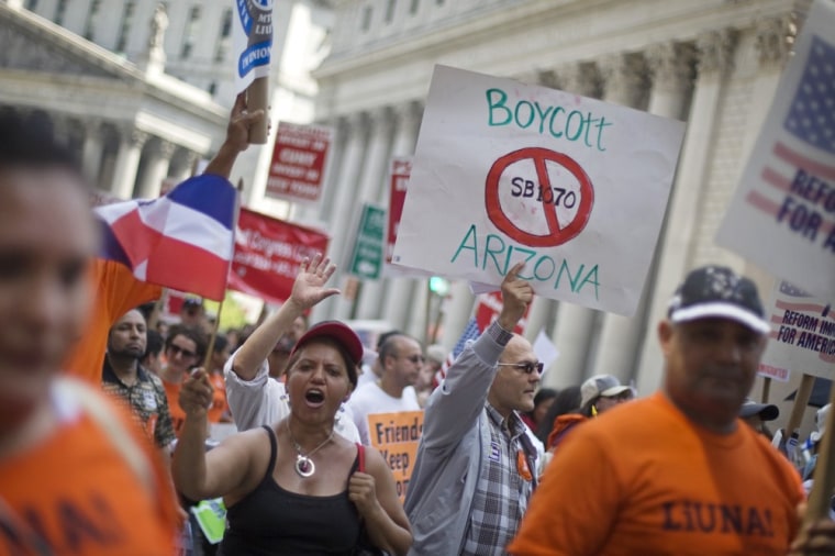 Demonstrators march in lower Manhattan to protest Arizona's controversial immigration law during a rally in New York on May 1, 2010.