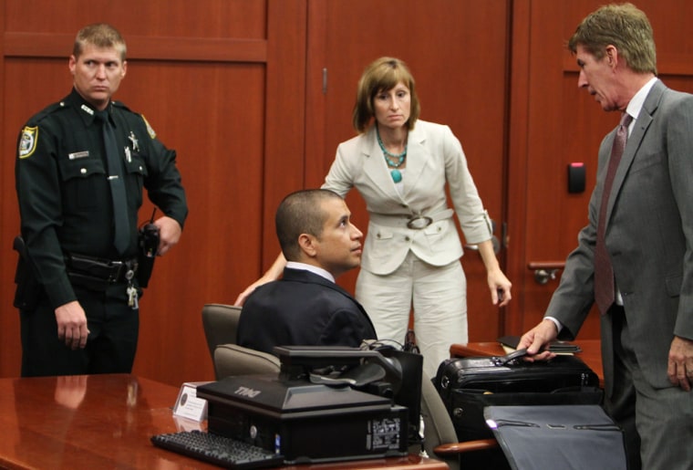 George Zimmerman, center, speaks with his attorney Mark O'Mara, right, during a bond hearing in front of a judge at the Seminole County Courthouse in Sanford, Florida, April 20. Zimmerman has pleaded not-guilt to second-degree murder in the February shooting death of 17-year-old Trayvon Martin.