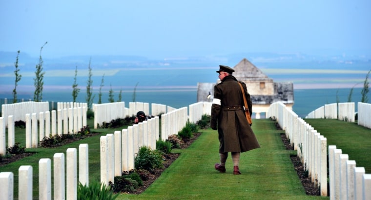 An Australian wearing an WWI uniform, walks past graves at the Australian War Memorial in the northern French city of Villers-Bretonneux, on April 25, as part of the Australian and New Zealand Army Corps (ANZAC) Day ceremony.