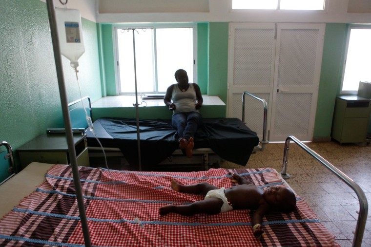 A mother watches her child receiving medical treatment at Simao Mendes Hospital.